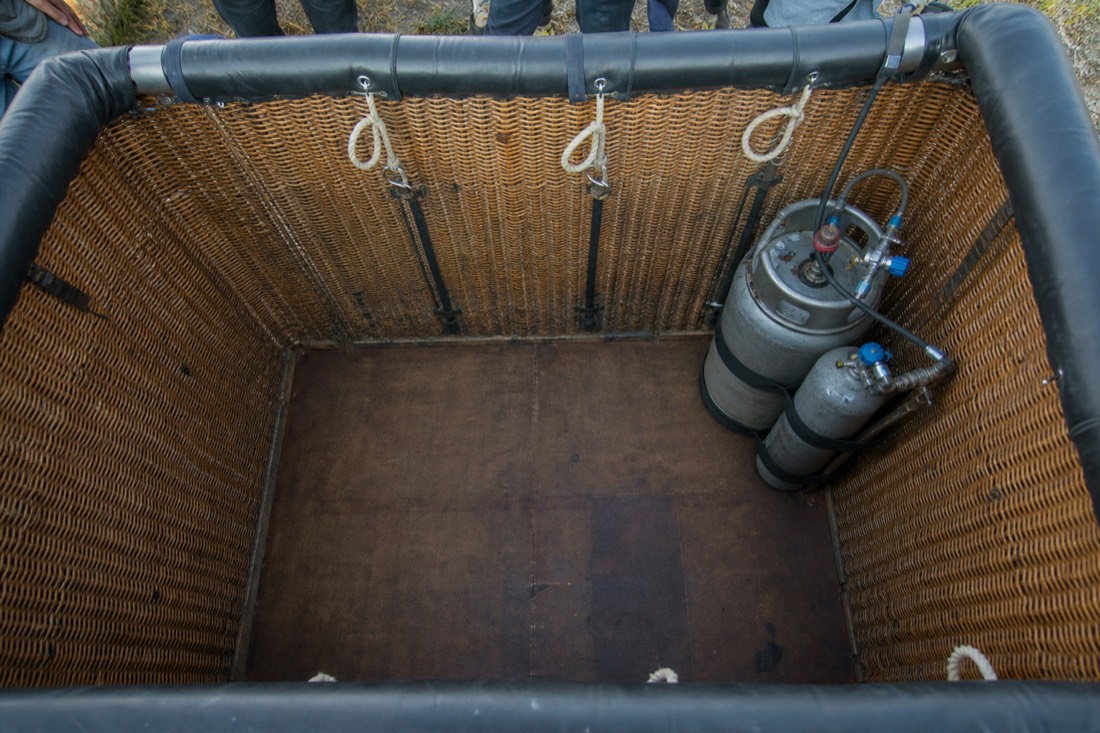 The interior of an empty balloon basket showing there is nowhere to sit